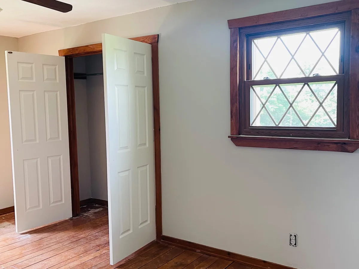 Freshly painted room with white walls and wood trim